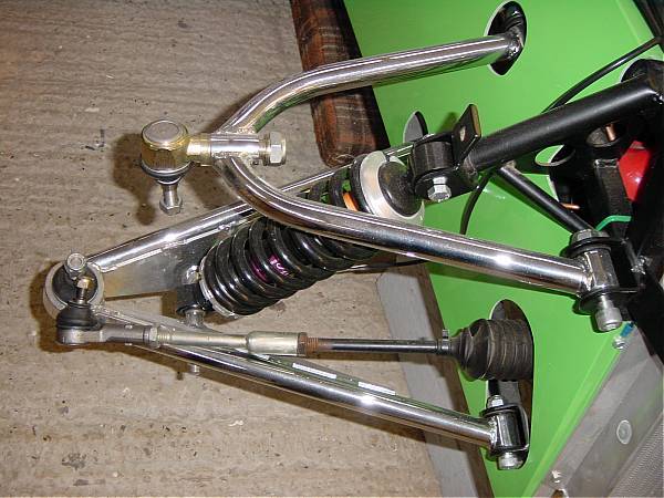Upper wishbone short side to rear.