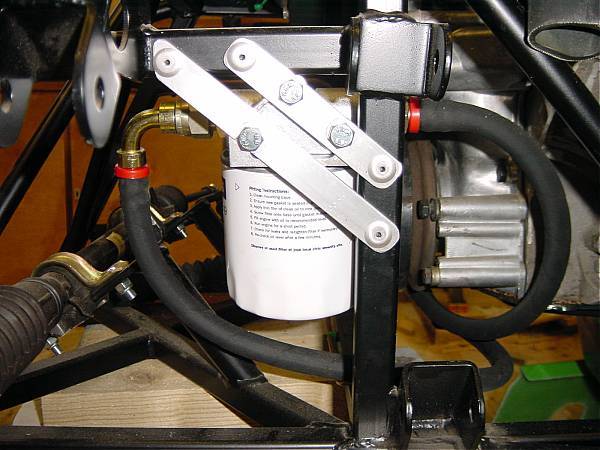 Oil hose run under timing cover.